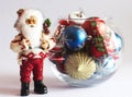 Santa Claus and Christmas tree toys in a round glass vase Royalty Free Stock Photo