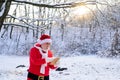 Santa Claus with Christmas wish list comes in the snow forest. Royalty Free Stock Photo