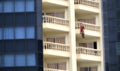 Santa Claus climbing a building in Christmas