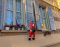 Santa Claus climbing on the window close-up. Christmas traditional decor. Royalty Free Stock Photo