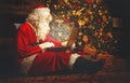 Santa Claus with computer before christmas Royalty Free Stock Photo