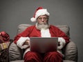 Santa Claus connecting with a laptop Royalty Free Stock Photo