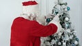 Santa Claus decorating Christmas tree Royalty Free Stock Photo