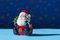 Santa Claus decorative figurine on blue background