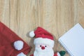 Santa Claus doll with Santa Claus red hat and notebook Royalty Free Stock Photo