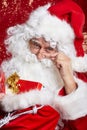 Santa Claus drinking tea Closeup Portrait Isolated on red Royalty Free Stock Photo