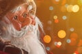 Santa Claus dummy toy with festive colorful string light bokeh background