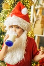 Santa Claus eating cookies and drinking milk on Christmas Eve. Happy santa claus eating a cookie and drinking glass of Royalty Free Stock Photo