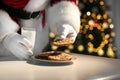 Santa Claus eating cookies and drinking milk at table, closeup Royalty Free Stock Photo