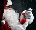 Santa Claus eating holding spoonful of red caviar fish salmon under snow. New year and Merry Christmas