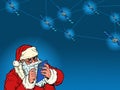 Santa Claus with an electronic tablet and global satellite Internet