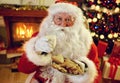 Santa Claus enjoying in cookies and milk Royalty Free Stock Photo