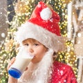 Christmas childs in snow. Santa Claus enjoys cookies and milk left out for him on Christmas eve. Merry Christmas. Santa