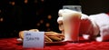 Santa Claus enjoys Milk and Cookies left out for him on Christmas Eve as he delivers gifts to all