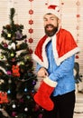 Santa Claus with excited face near Christmas tree and garlands Royalty Free Stock Photo