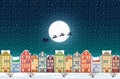 Santa Claus flies over a decorated snowy old city town near moon at Christmas eve.