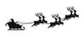 Santa Claus is flying in sleigh with Christmas reindeer. Silhouette of Santa Claus, sleigh with Christmas presents and reindeer Royalty Free Stock Photo