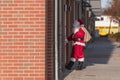 A Santa Claus at a front door in the city Royalty Free Stock Photo