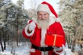 Santa Claus gesturing thumb up outdoors. Royalty Free Stock Photo