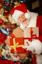 Santa Claus is getting ready for Christmas, he is packing children& x27;s gifts. Christmas decoration.