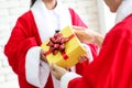 Santa Claus with gift box giving a Christmas present to her,Mer Royalty Free Stock Photo