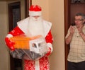 Santa Claus with gifts and grandfather surprised