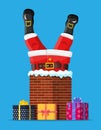 Santa claus with gifts stuck in house chimney. Royalty Free Stock Photo