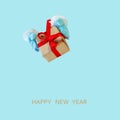 Santa Claus gives a present - gift box with red ribbon, copy space isolated on light blue background. Royalty Free Stock Photo