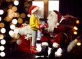 Santa Claus giving Christmas gift to little girl near window Royalty Free Stock Photo