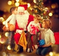 Santa Claus giving Christmas gifts to children Royalty Free Stock Photo