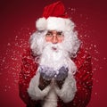 Santa Claus with glasses blowing snow Royalty Free Stock Photo