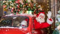 Santa claus greeting while driving a red retro car. Merry Christmas Royalty Free Stock Photo