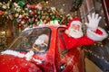 Santa claus greeting while driving a red retro car. Merry Christmas Royalty Free Stock Photo