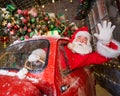 Santa claus greeting while driving a red retro car. Merry Christmas Royalty Free Stock Photo