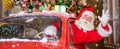 Santa claus greeting while driving a red retro car. Merry Christmas. Widescreen. Royalty Free Stock Photo