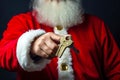 Santa Claus hand holding key from new apartment or auto