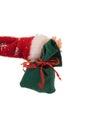 Santa Claus hand holds a green sack with presents