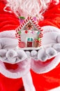 Santa Claus hands holding a house model Royalty Free Stock Photo