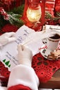 Santa Claus handwriting a letter with a quill pen