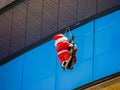 Santa Claus is hanging on the glass surface of the house Royalty Free Stock Photo