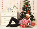 Santa Claus with happy face near bureau and Christmas tree Royalty Free Stock Photo