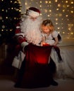 Santa Claus with happy little cute children boy and girl near Christmas tree Royalty Free Stock Photo