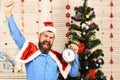 Santa Claus with happy winners face near Christmas tree Royalty Free Stock Photo