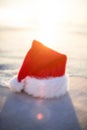 Santa claus hat on beach against sunny sky Royalty Free Stock Photo