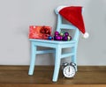 Santa claus hat on chair with presents Royalty Free Stock Photo