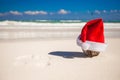 Santa Claus hat at coconut on a white sandy beach Royalty Free Stock Photo