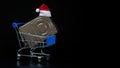 Santa Claus hat on a hard drive in a shopping cart. The concept of seasonal New Year and Christmas discounts on electronics and Royalty Free Stock Photo