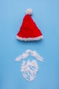 A Santa Claus hat with mustage on blue background. Royalty Free Stock Photo