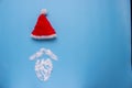 A Santa Claus hat with mustage on blue background. Royalty Free Stock Photo