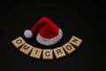 A Santa Claus hat with the name of new variant of Covid-19, Omicron, written next to it Royalty Free Stock Photo